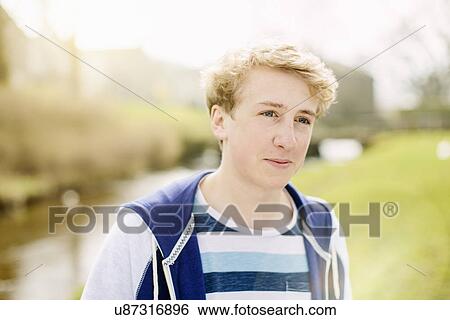 Portrait of teenage boy by rural river View Large Photo Image Stock Photograph - Portrait of teenage boy by rural river. Fotosearch