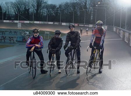 Stock Image - Portrait of young adult cyclists at velodrome. Fotosearch