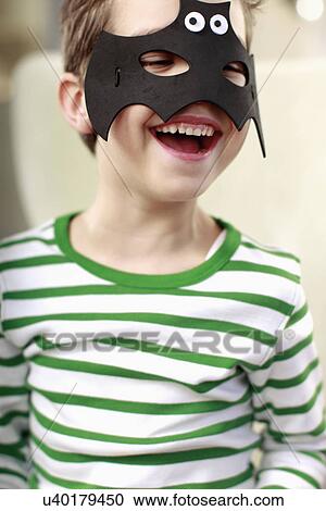 Stock Image - Portrait of young boy in bat mask. Fotosearch