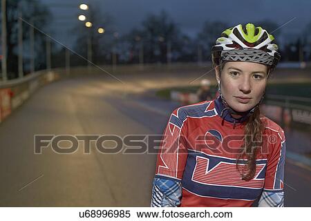 Portrait of young female cyclist at velodrome at night View Large Photo Image Stock Photography - Portrait of young female cyclist at velodrome at night. Fotosearch