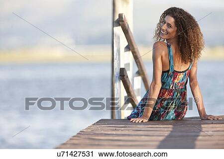 Portrait of young woman on jetty View Large Photo Image Stock Image - Portrait of young woman on jetty. Fotosearch