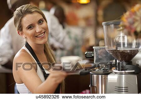Portrait of young woman preparing cup of coffee in cafe View Large Photo Image Stock Photograph - Portrait of young woman preparing cup of coffee in cafe. Fotosearch
