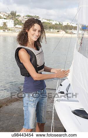 Portrait of young woman preparing sailboat View Large Photo Image Picture - Portrait of young woman preparing sailboat. Fotosearch