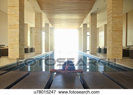 Stock Photo - Portrait of young woman relaxing in spa swimming pool. Fotosearch
