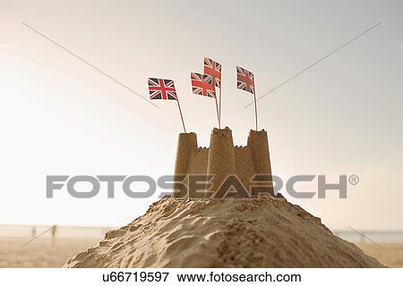 Stock Photo - Sandcastle with union jack flags. Fotosearch