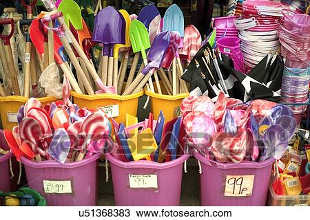 Stock Image - Shop display selling buckets and spades. Fotosearch