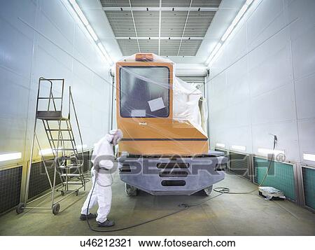 Stock Image - Technician paint spraying in truck repair factory. Fotosearch