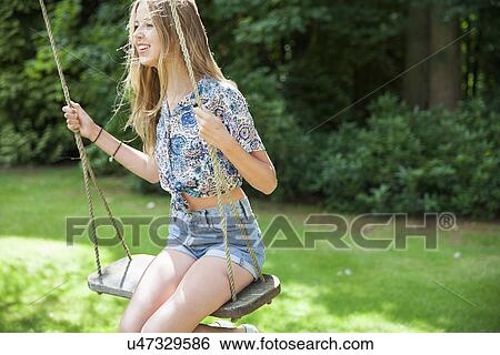 Teenage girl on swing View Large Photo Image Stock Photograph - Teenage girl on swing. Fotosearch