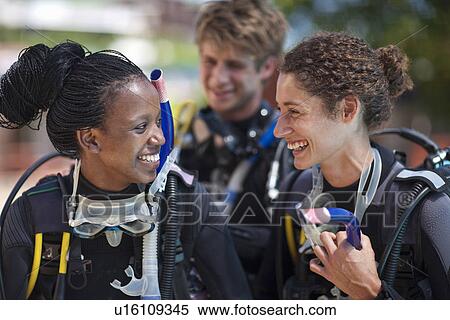 Three young adult scuba divers preparing for pool practice View Large Photo Image Stock Photography - Three young adult scuba divers preparing for pool practice. Fotosearch