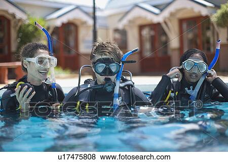 Three young adult scuba divers training in swimming pool View Large Photo Image Stock Photo - Three young adult scuba divers training in swimming pool. Fotosearch