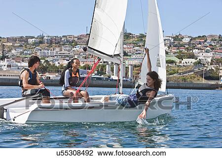 Three young friends sailing in harbor View Large Photo Image Stock Image - Three young friends sailing in harbor. Fotosearch