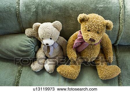 Two teddy bears sitting on sofa View Large Photo Image Stock Image - Two teddy bears sitting on sofa. Fotosearch