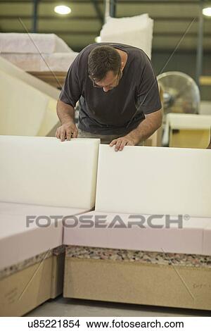 Upholsterer checking furniture box frame View Large Photo Image Picture - Upholsterer checking furniture box frame. Fotosearch