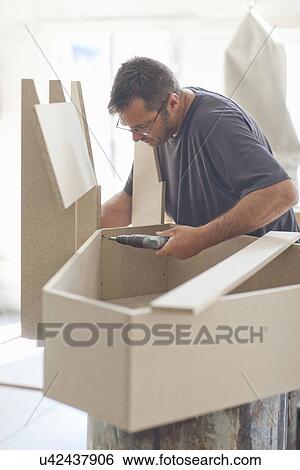 Upholsterer drilling furniture box frame View Large Photo Image Stock Photograph - Upholsterer drilling furniture box frame. Fotosearch