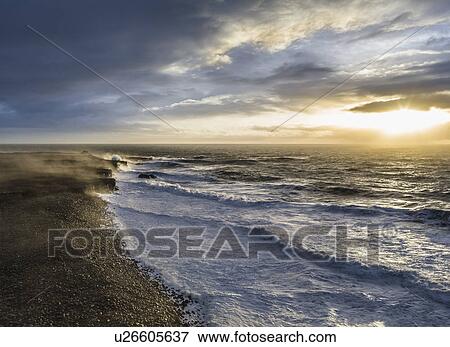 Stock Photo - View of stormy sky and sea at sunrise, Reykjanes, Iceland. Fotosearch