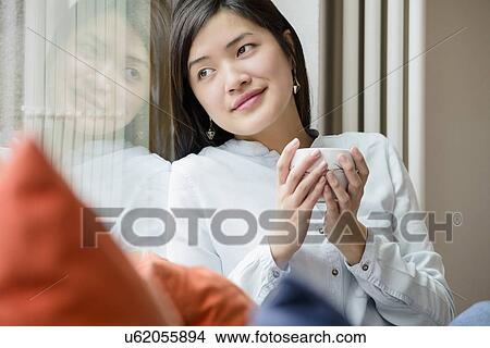 Woman relaxing with cup of tea View Large Photo Image Picture - Woman relaxing with cup of tea. Fotosearch