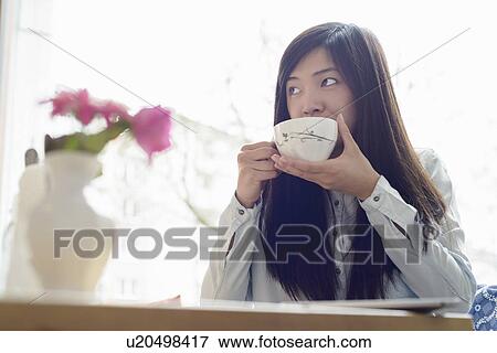 Woman relaxing with cup of tea View Large Photo Image Stock Photo - Woman relaxing with cup of tea. Fotosearch