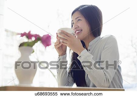 Woman relaxing with cup of tea View Large Photo Image Stock Photography - Woman relaxing with cup of tea. Fotosearch
