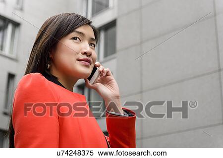 Stock Photography - Woman using cellular phone. Fotosearch