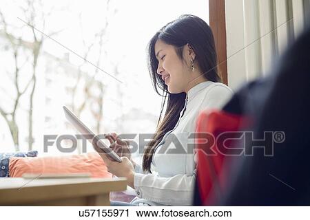 Woman using digital tablet View Large Photo Image Stock Image - Woman using digital tablet. Fotosearch