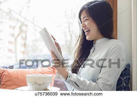 Woman using digital tablet View Large Photo Image Stock Photo - Woman using digital tablet. Fotosearch
