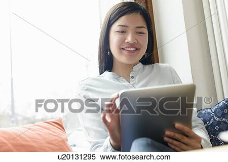 Woman using digital tablet View Large Photo Image Stock Photography - Woman using digital tablet. Fotosearch