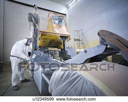 Worker paint spraying truck in factory View Large Photo Image Stock Photo - Worker paint spraying truck in factory. Fotosearch