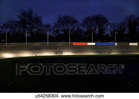 Young adult cyclists racing on velodrome track View Large Photo Image Picture - Young adult cyclists racing on velodrome track. Fotosearch