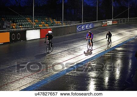 Young adult cyclists racing on velodrome track View Large Photo Image Stock Photo - Young adult cyclists racing on velodrome track. Fotosearch