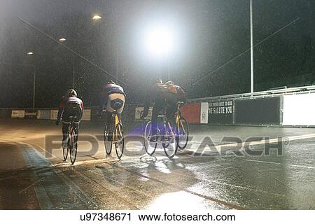 Young adult cyclists racing over finishing line at velodrome View Large Photo Image Stock Image - Young adult cyclists racing over finishing line at velodrome. Fotosearch