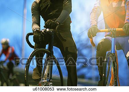 Young adult cyclists waiting at start line on velodrome track View Large Photo Image Stock Image - Young adult cyclists waiting at start line on velodrome track. Fotosearch