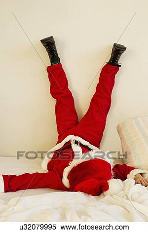 Young boy dressed up as santa claus on bed with legs raised View Large Photo Image Stock Photography - Young boy dressed up as santa claus on bed with legs raised. Fotosearch
