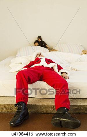 Young boy dressed up as santa claus lying on bed View Large Photo Image Stock Photography - Young boy dressed up as santa claus lying on bed. Fotosearch