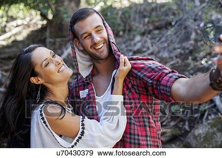 Stock Photo - Young couple fooling around in forest. Fotosearch