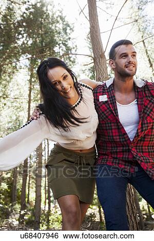 Young couple fooling around in forest View Large Photo Image Stock Photograph - Young couple fooling around in forest. Fotosearch