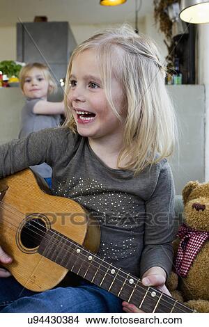 Young girl playing acoustic guitar View Large Photo Image Picture - Young girl playing acoustic guitar. Fotosearch