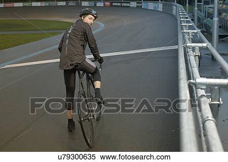 Stock Photography - Young male cyclist at velodrome starting line. Fotosearch