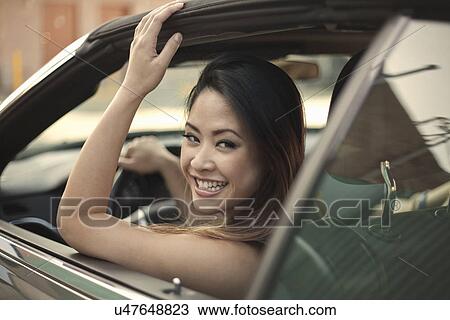 Young woman looking out of car window View Large Photo Image Stock Image - Young woman looking out of car window. Fotosearch