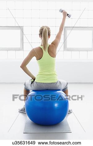 sitting on a swiss ball