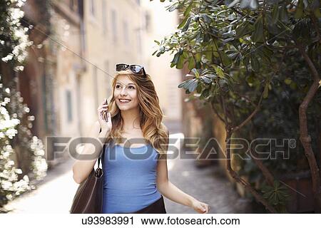 Young woman strolling on quaint street, Rome, Italy View Large Photo Image Stock Image - Young woman strolling on quaint street, Rome, Italy. Fotosearch
