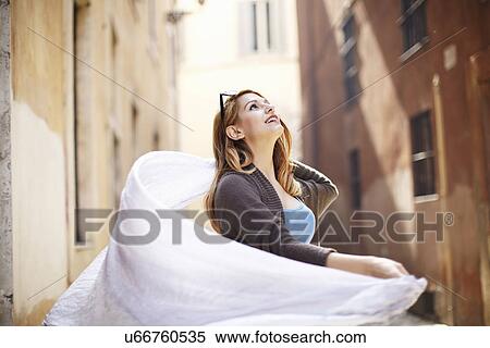 Young woman swirling her scarf on street, Rome, Italy View Large Photo Image Stock Photography - Young woman swirling her scarf on street, Rome, Italy. Fotosearch