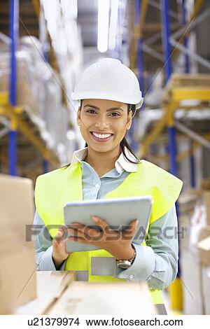 Young woman with digital tablet in distribution warehouse View Large Photo Image Picture - Young woman with digital tablet in distribution warehouse. Fotosearch