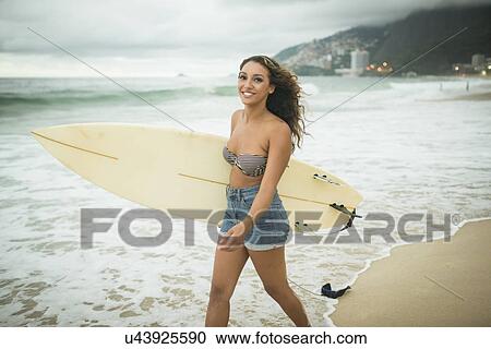 Young woman with surfboard View Large Photo Image Stock Image - Young woman with surfboard. Fotosearch