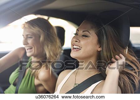 Young women in car, laughing View Large Photo Image Picture - Young women in car, laughing. Fotosearch