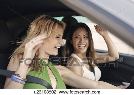 Young women in car, laughing View Large Photo Image Stock Image - Young women in car, laughing. Fotosearch