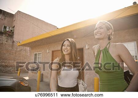 Stock Image - Young women outside motel. Fotosearch