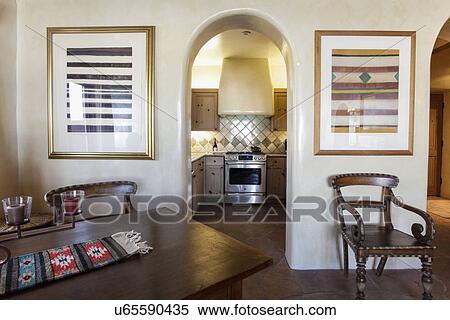 Arched way leading to kitchen with cropped dining area in foreground; Santa Fe; New Mexico; USA View Large Photo Image Stock Photography - Arched way leading to kitchen with cropped dining area in foreground; Santa Fe; New Mexico; USA. Fotosearch