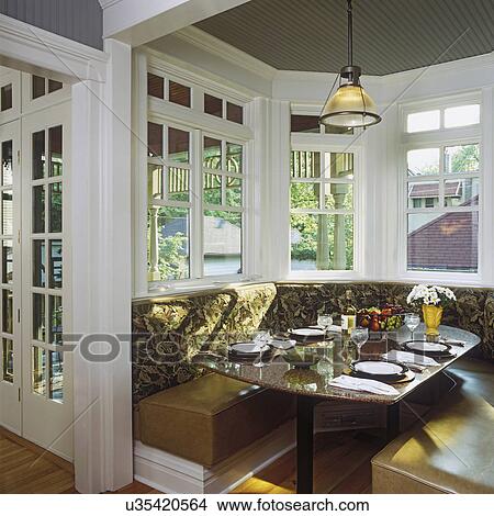 Bay window with booth like seating around table at home View Large Photo Image Picture - Bay window with booth like seating around table at home. Fotosearch