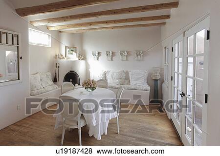 Chairs at round table with built in couch and French doors at home; Santa Fe; New Mexico; USA View Large Photo Image Stock Photo - Chairs at round table with built in couch and French doors at home; Santa Fe; New Mexico; USA. Fotosearch
