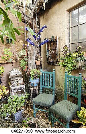 Stock Image - Chairs in the garden; Taos; New Mexico; USA. Fotosearch